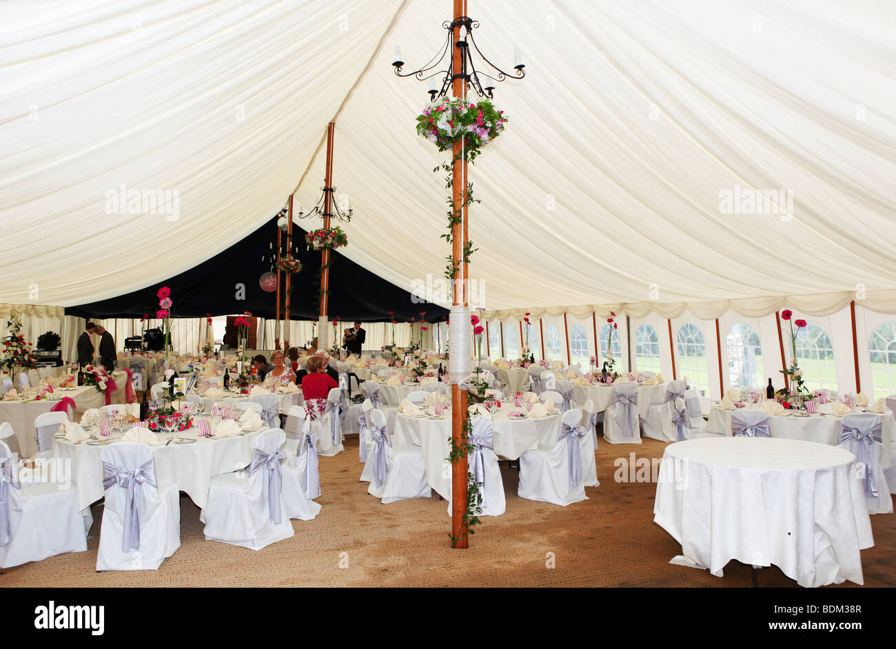 Large Marquee set up decorated for luxury wedding breakfast reception at summer wedding in UK Stock Photo