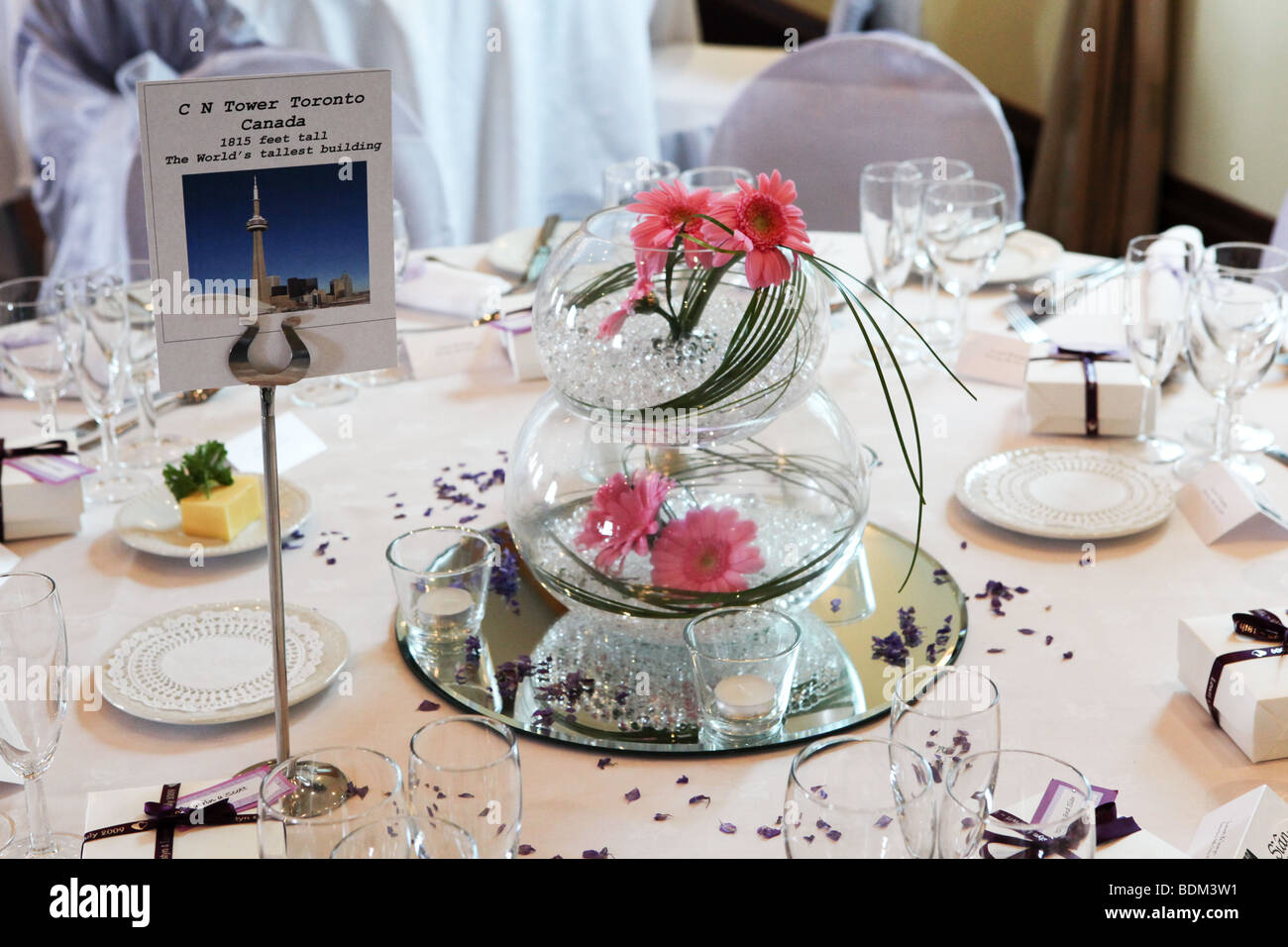 Wedding breakfast reception table decorations closeup, table name card and  flowers in bowl Stock Photo - Alamy