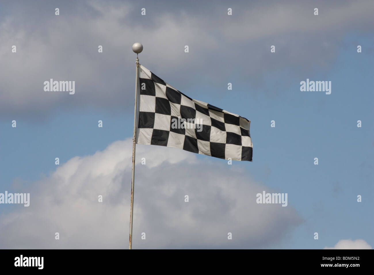 Checkered flag blowing in the breeze. Stock Photo