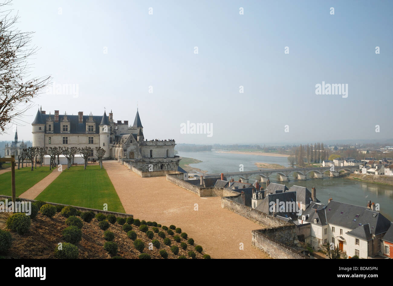 Medieval castle above valley of Loire with bridge, river and town Amboise Stock Photo