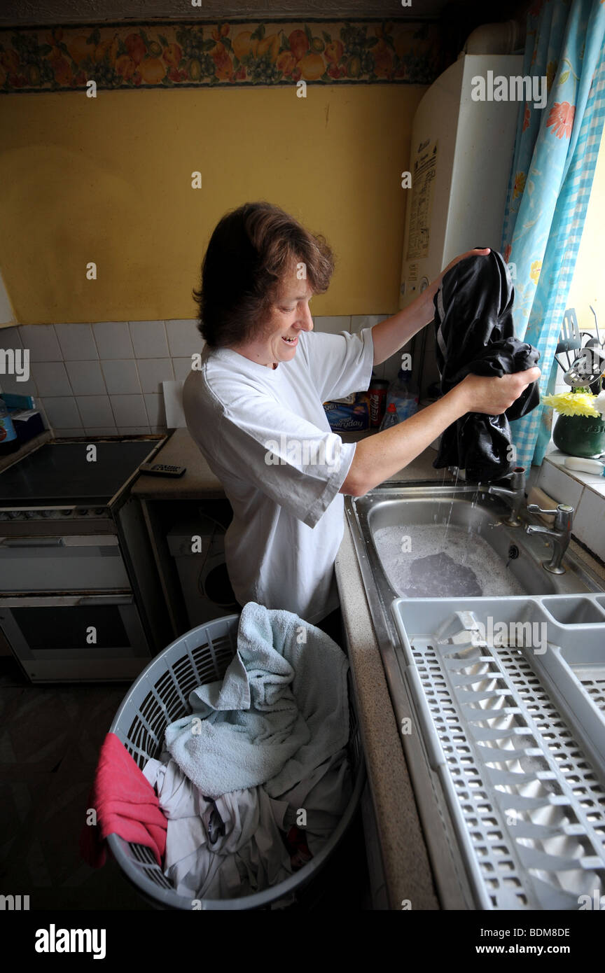 Woman Washing Her Clothes In The Kitchen Sink Domestic