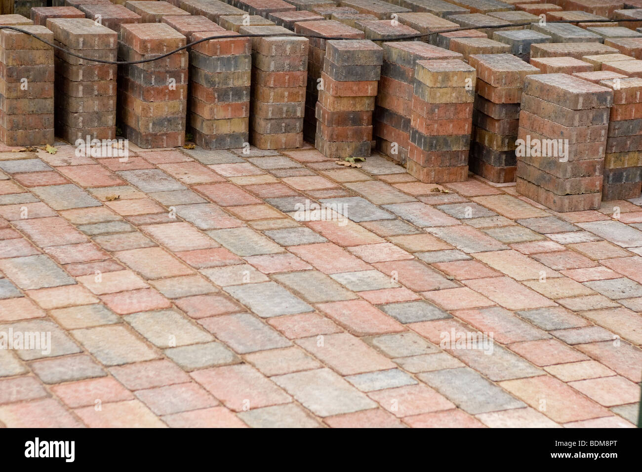 A pile of paving brick on a driveway. Stock Photo