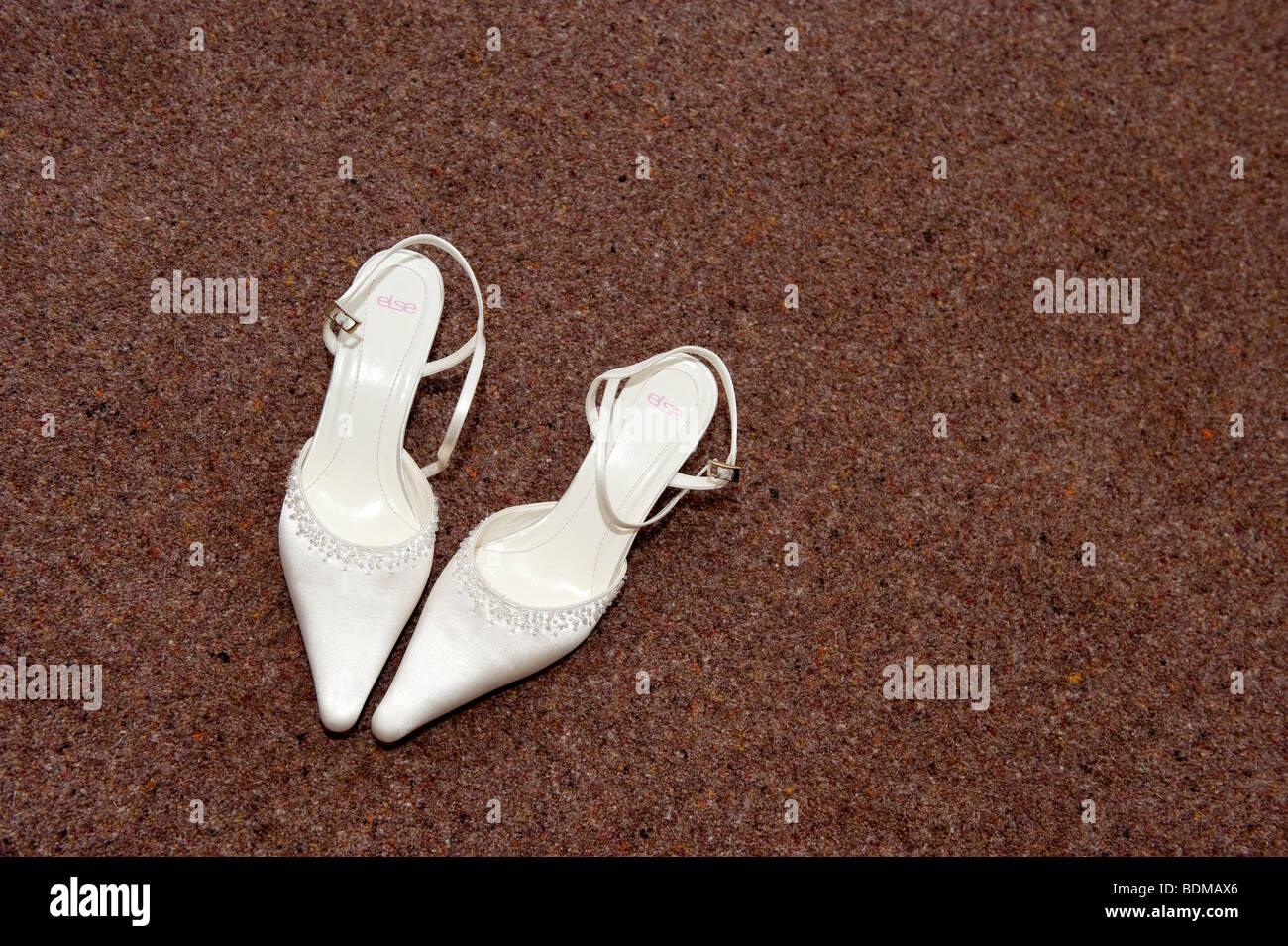 Brides shoes on carpeted floor Stock Photo