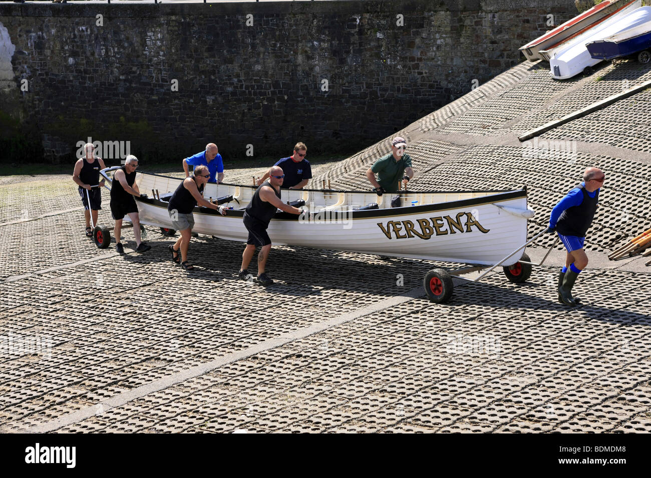Crewmen of the Gig rowing boat called the Verbena wheel the boat up the