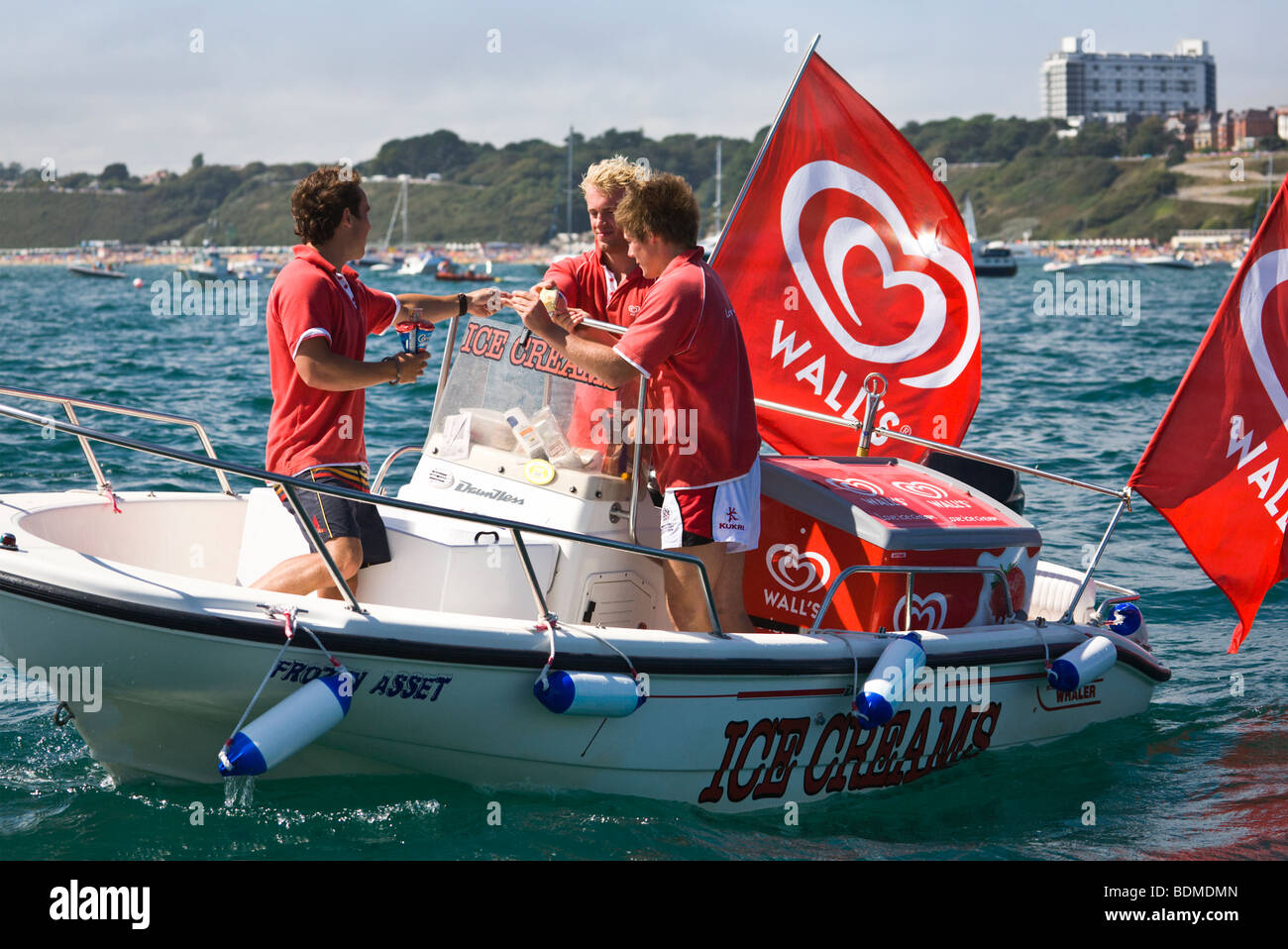 Ice cream sellers. Young men selling ice cream from a boat off Bournemouth beach. Dorset. UK. Stock Photo