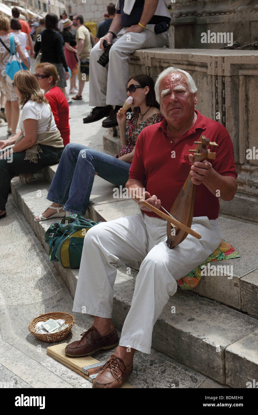 Street musician in the Old City of Dubrovnik, Croatia. Stock Photo