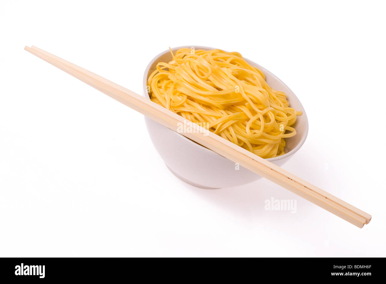 chopsticks,bowl and noodles on white background Stock Photo