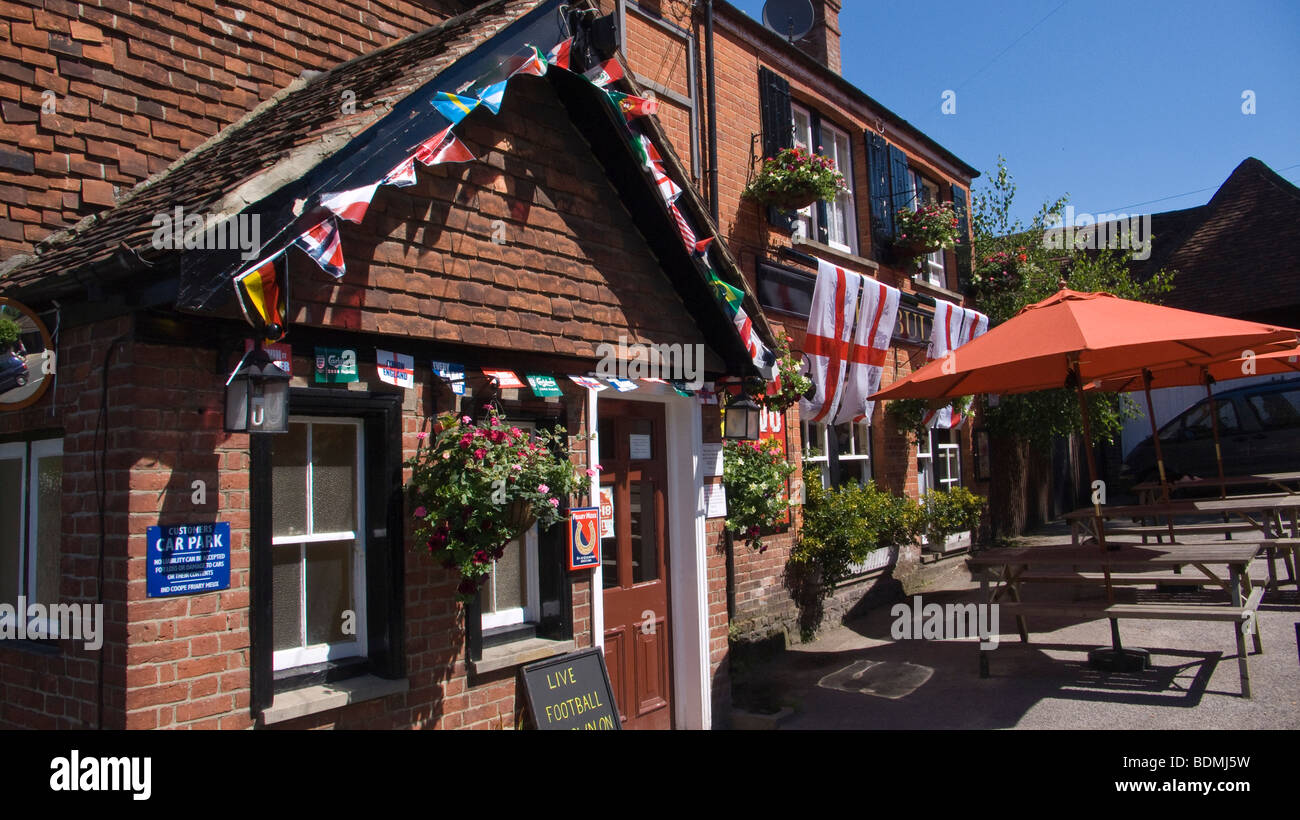 St. flags outside the Bull Inn, Limpsfield. Surrey, England