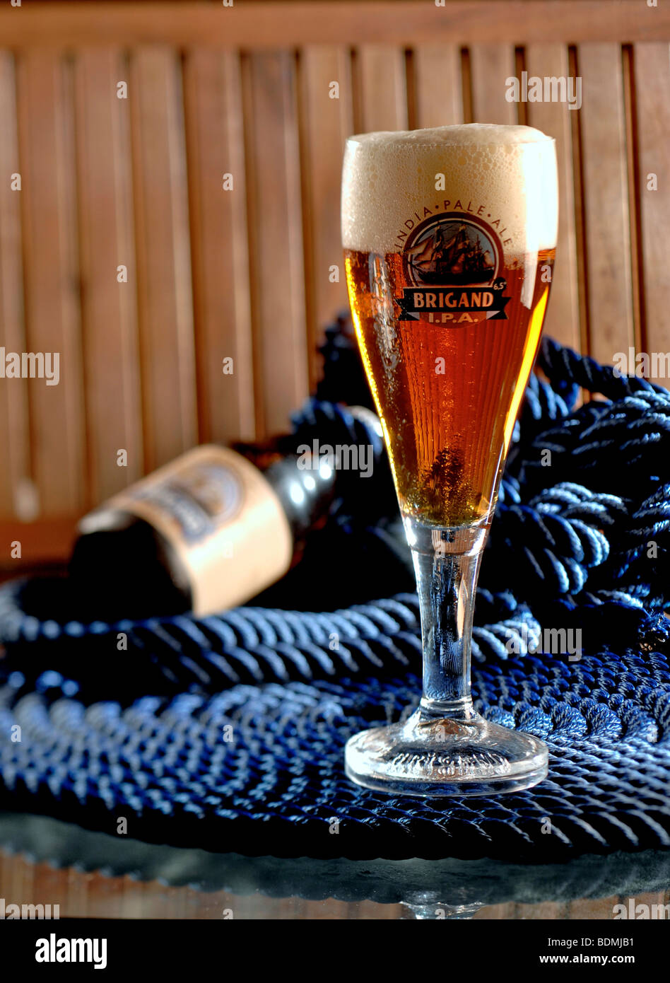 Glass and bottle of Brigand IPA Belgian beer. Stock Photo