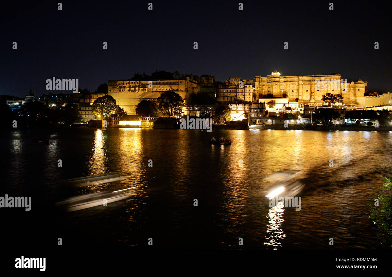 The illuminated City Palace in Udaipur on Lake Pichola at night, Rajasthan, India Stock Photo