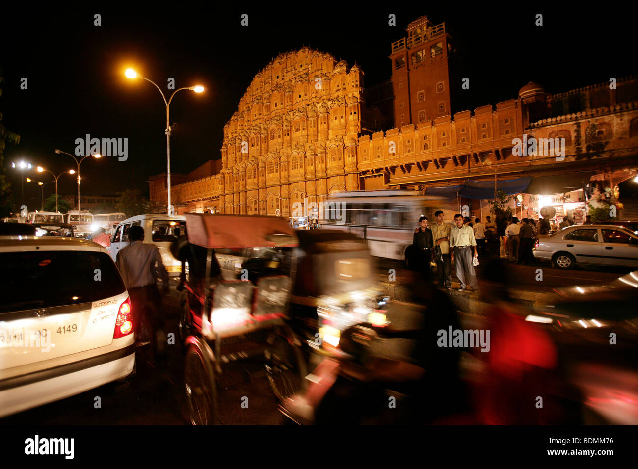 Nightly road scene in front of the Hawa Mahal, the Palace of Winds in Jaipur, Rajasthan, India Stock Photo