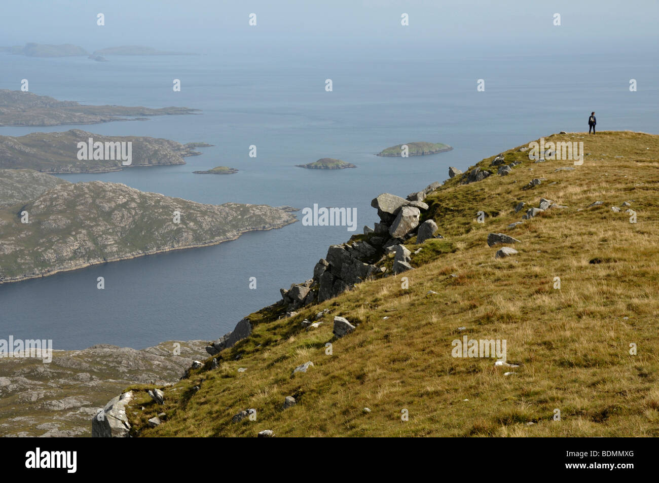 Walker on summit ridge of Todun, Isle of Harris, Scotland Stock Photo