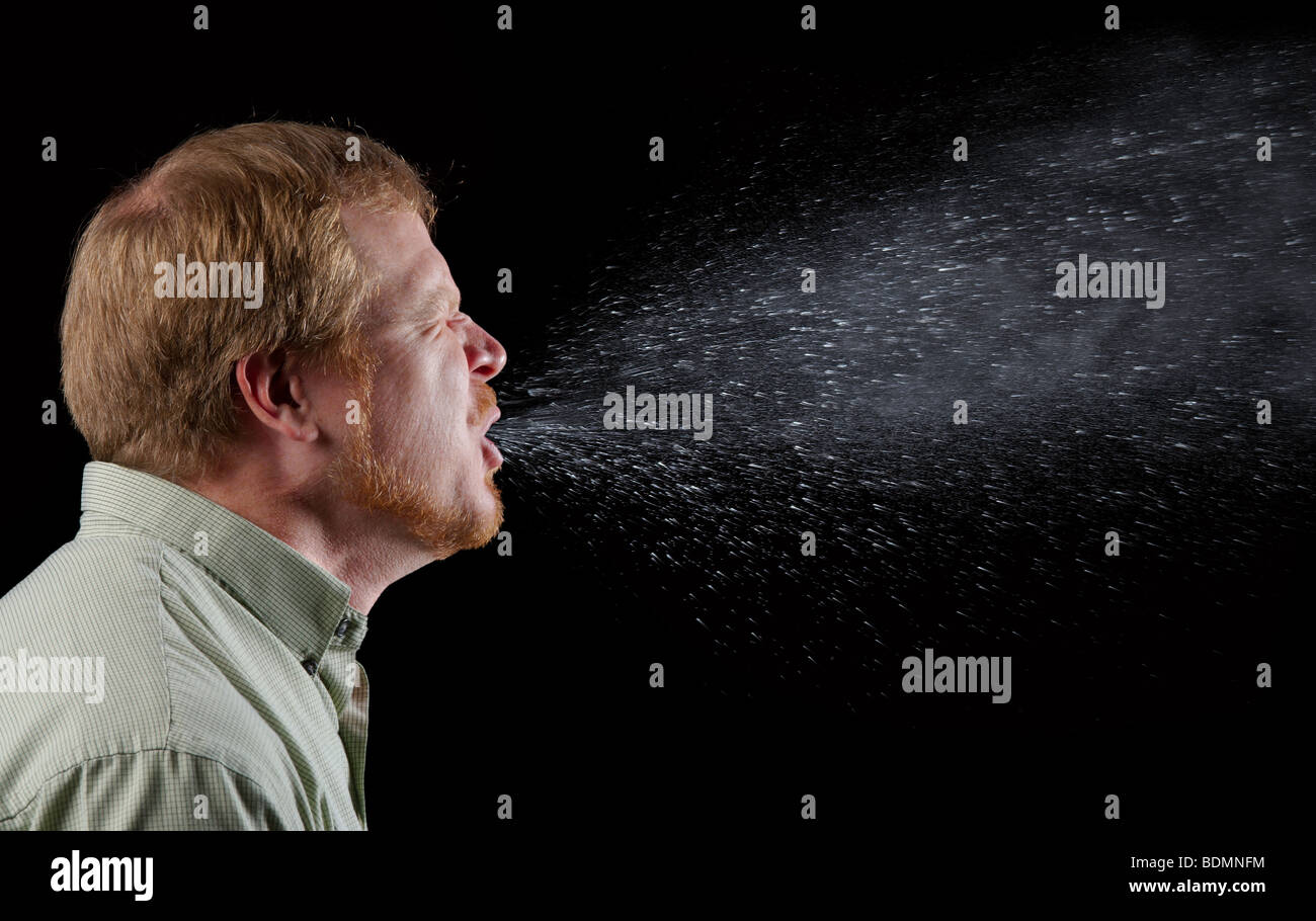 man sneezing, showing the spray of mucus and saliva that is potentially