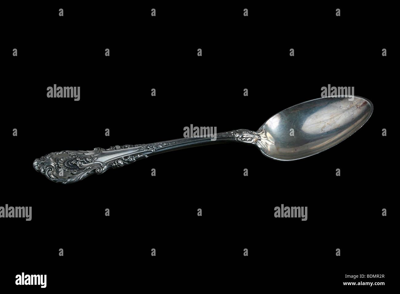 Vintage silver spoon isolated on black. Stock Photo
