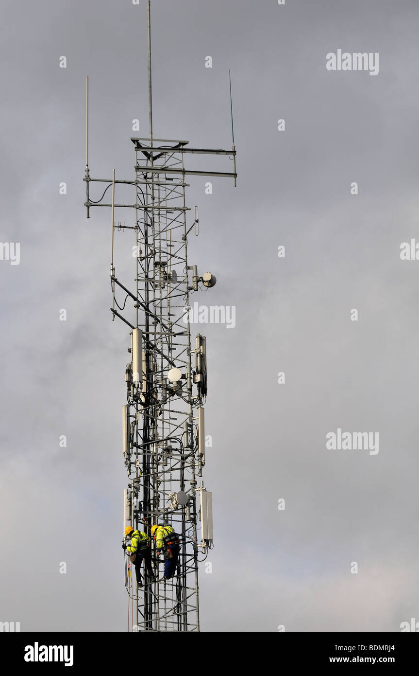 Two men at work on a mobile phone network antenna in Dublin Ireland