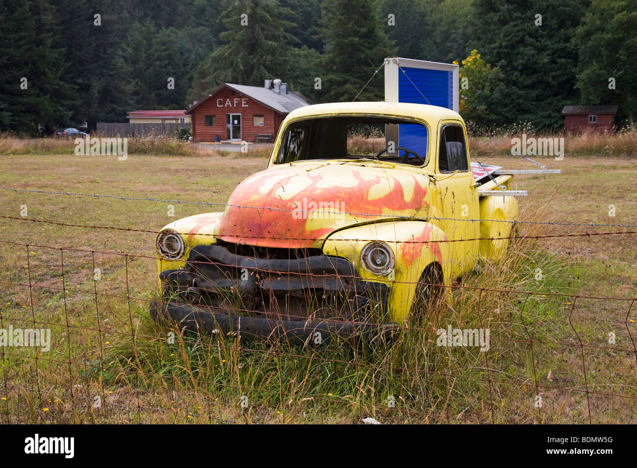 An ancient Chevrolet pickup truck rusting in a field in the Oregon Coast Range near Philomath. Stock Photo