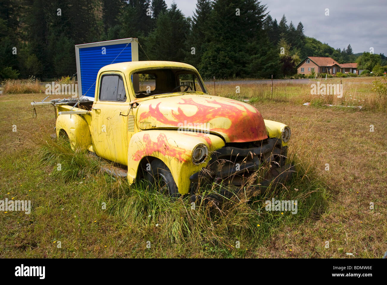 An ancient Chevrolet pickup truck rusting in a field in the Oregon Coast Range near Philomath. Stock Photo