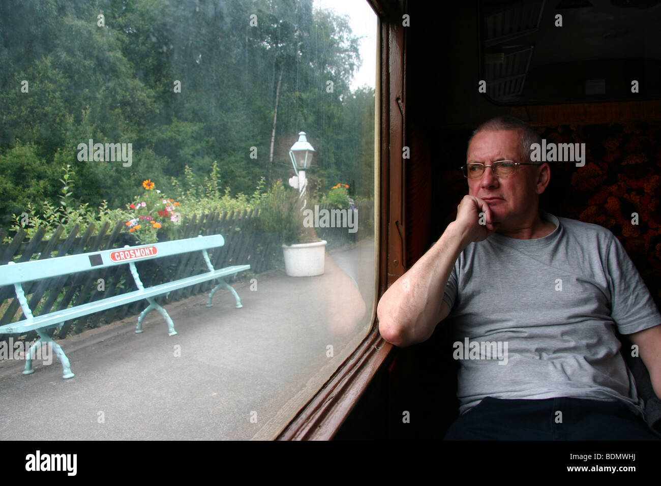 NYMR, Man on a train looking out of the window, Grosmont Station, North York Moors Railway, North Yorkshire, England, UK Stock Photo