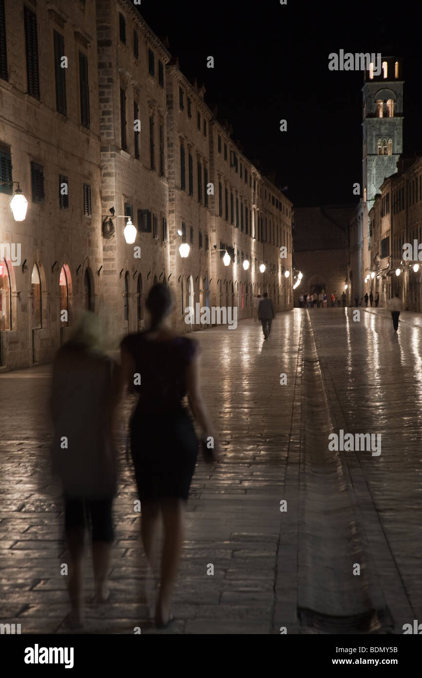 The Placa Stradum at late night in the old town of Dubrovnik with two ghostly females walking down the main street Stock Photo