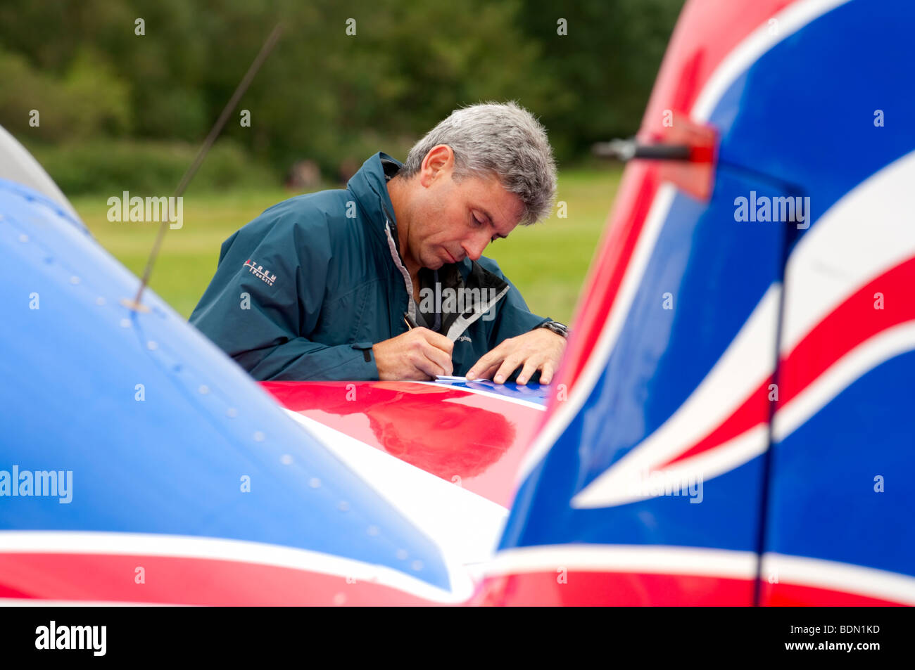 Red Bull Matador pilot Paul Bonhomme prepares notes for his aerial display routine at Dunsfold Wings & Wheels 2009 Stock Photo