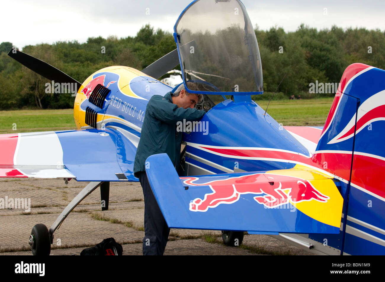 Red Bull Matador pilot Paul Bonhomme prepares his aircraft prior to his aerial display routine at Dunsfold Wings & Wheels 2009 Stock Photo