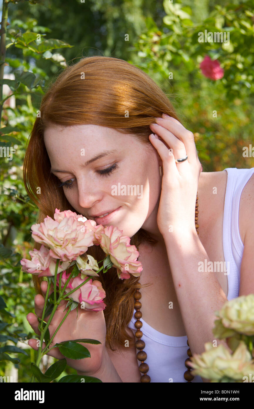 Young woman with rose bloom Stock Photo