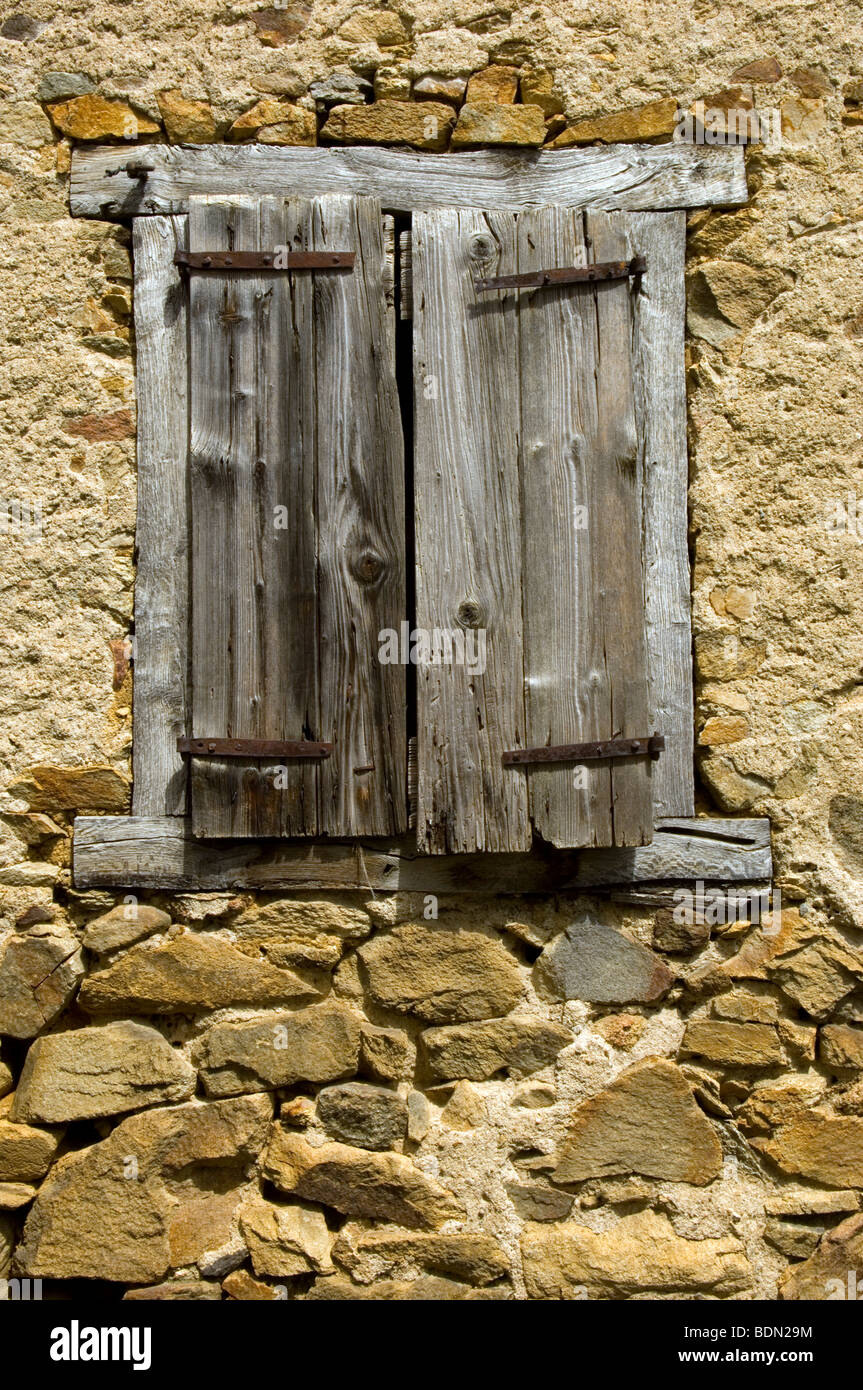 Wooden Shutters in Stone House Stock Photo