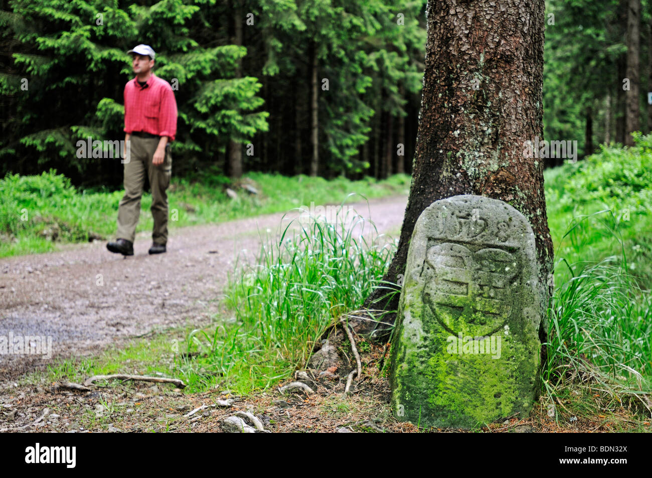 Historical border stone on the border of principalities, in the back hikers, Rennsteig, Thuringian Forest, Thuringia, Germany,  Stock Photo