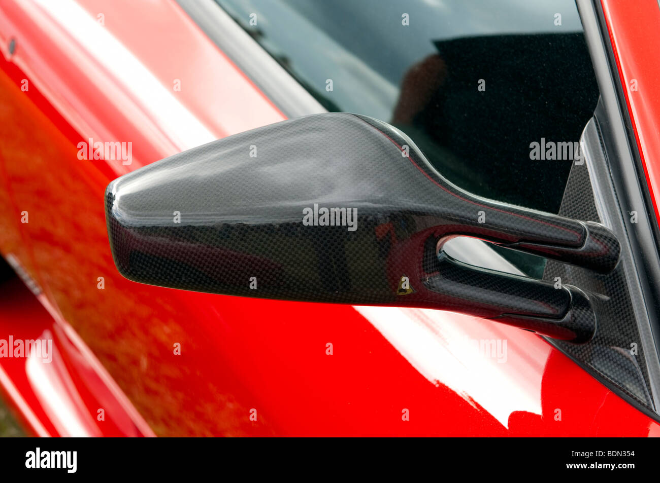 Detail of carbon fibre Ferrari 430 Scuderia wing mirror Stock Photo
