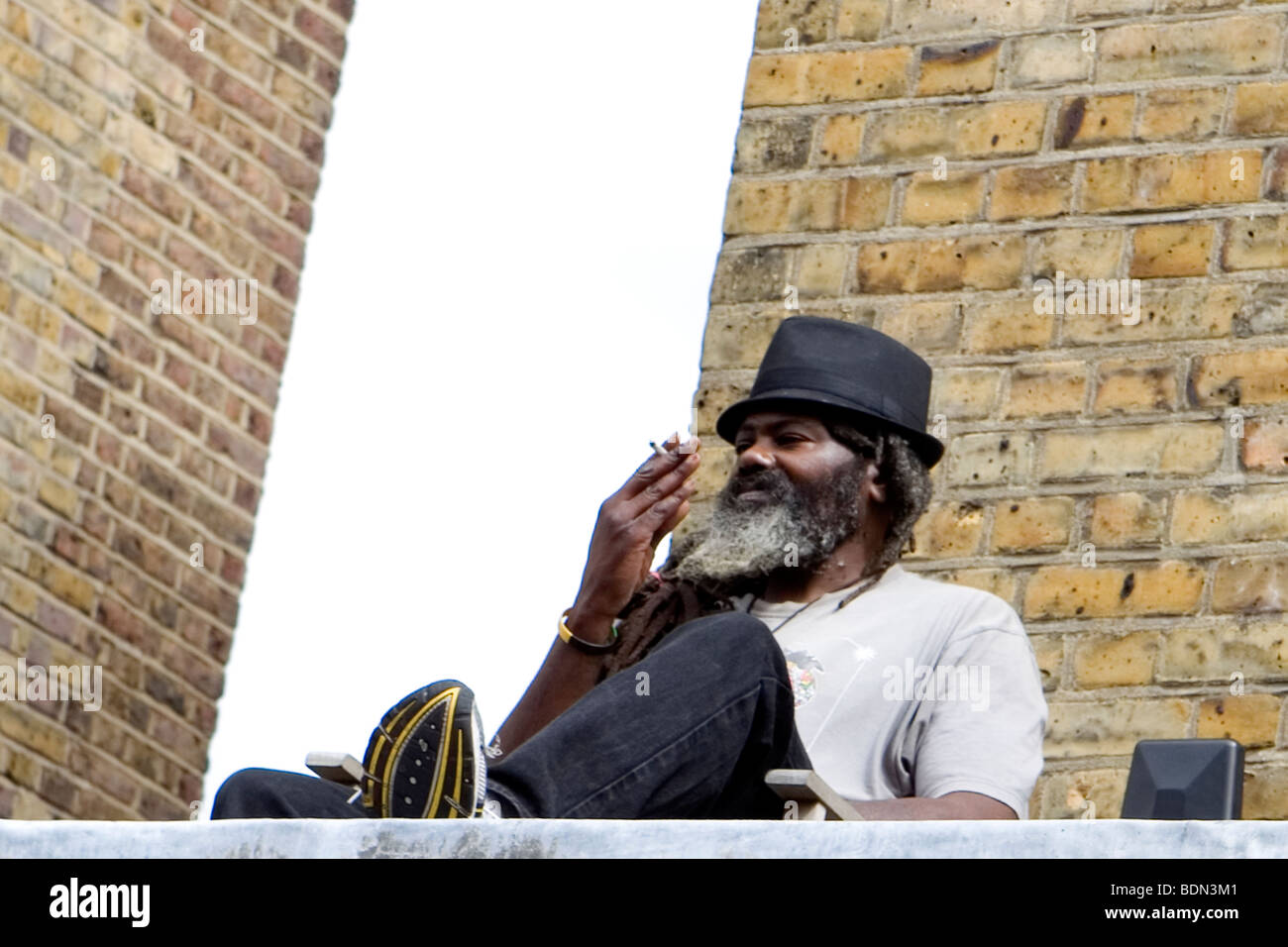 Jamaican man smoking joint on roof Stock Photo