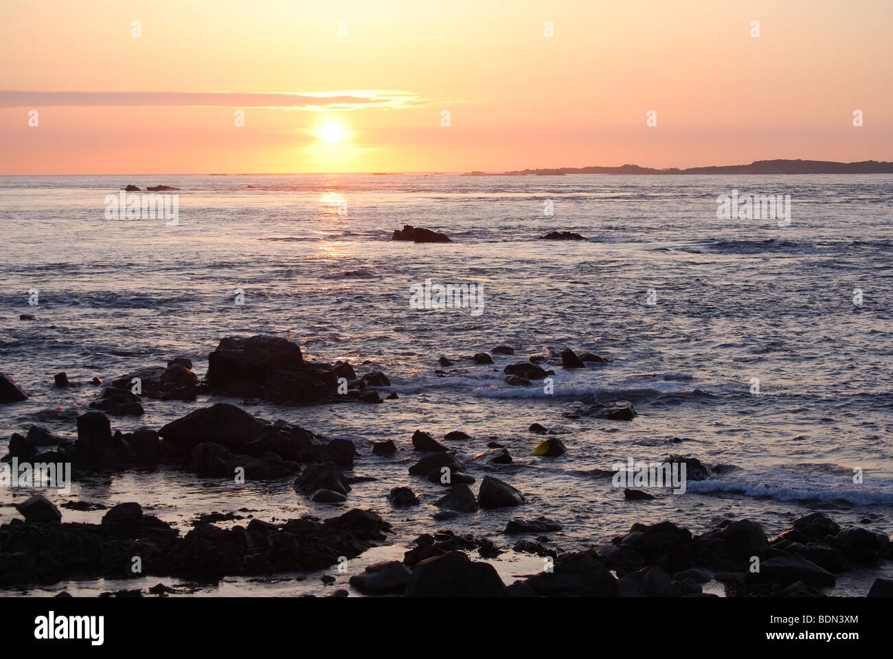 Sunset over Burhou island, Alderney, Channel Islands Stock Photo