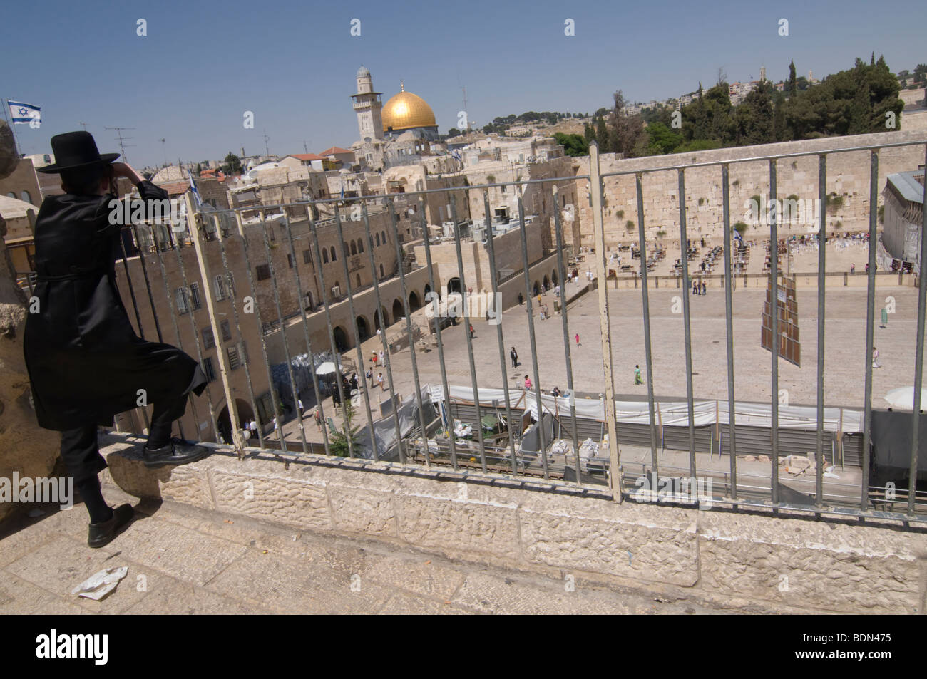 A Hasidic Jewish young man enjoys a panoramic view of the Western Wall and Al-Haram al-Sharif (Noble Sanctuary). Stock Photo