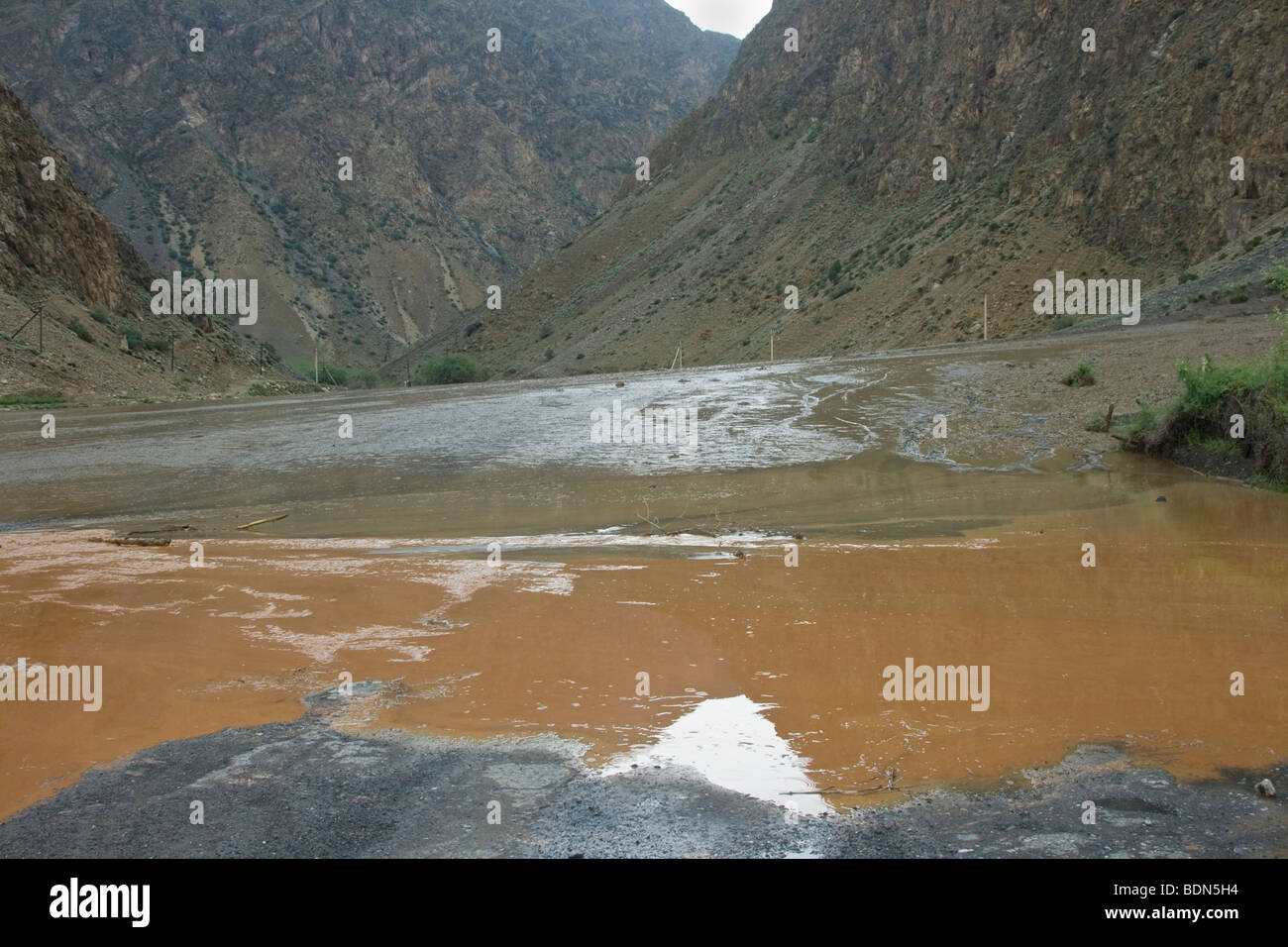 Mudslide covering the road in rural Kyrgyzstan Stock Photo