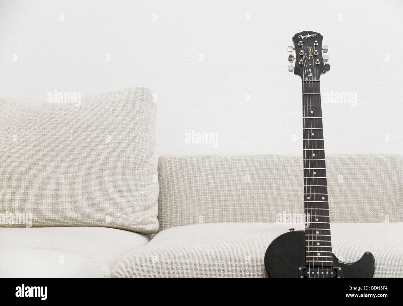 Sofa with electric guitar Stock Photo Alamy