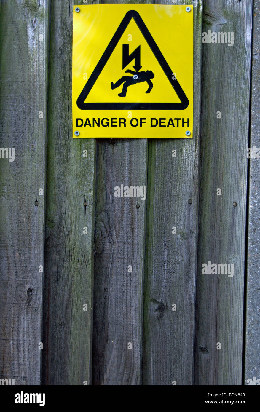 danger of death sign on a wooden fence surrounding an electricity substation, in kew, southwest london, england Stock Photo
