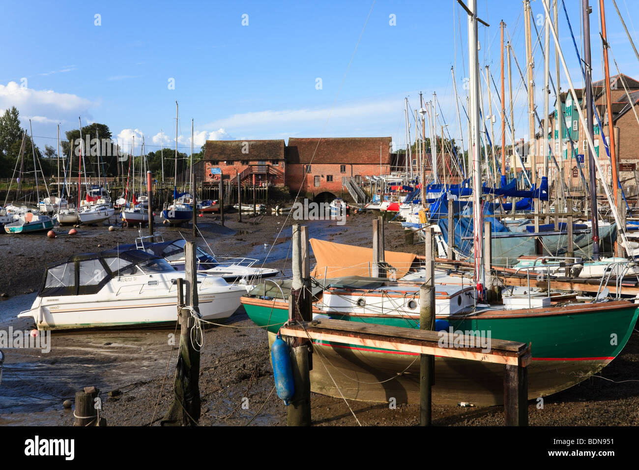 Low tide at Eling Creek at the top of Southampton Water, With moored boats and Tide Mill, Southampton, UK Stock Photo
