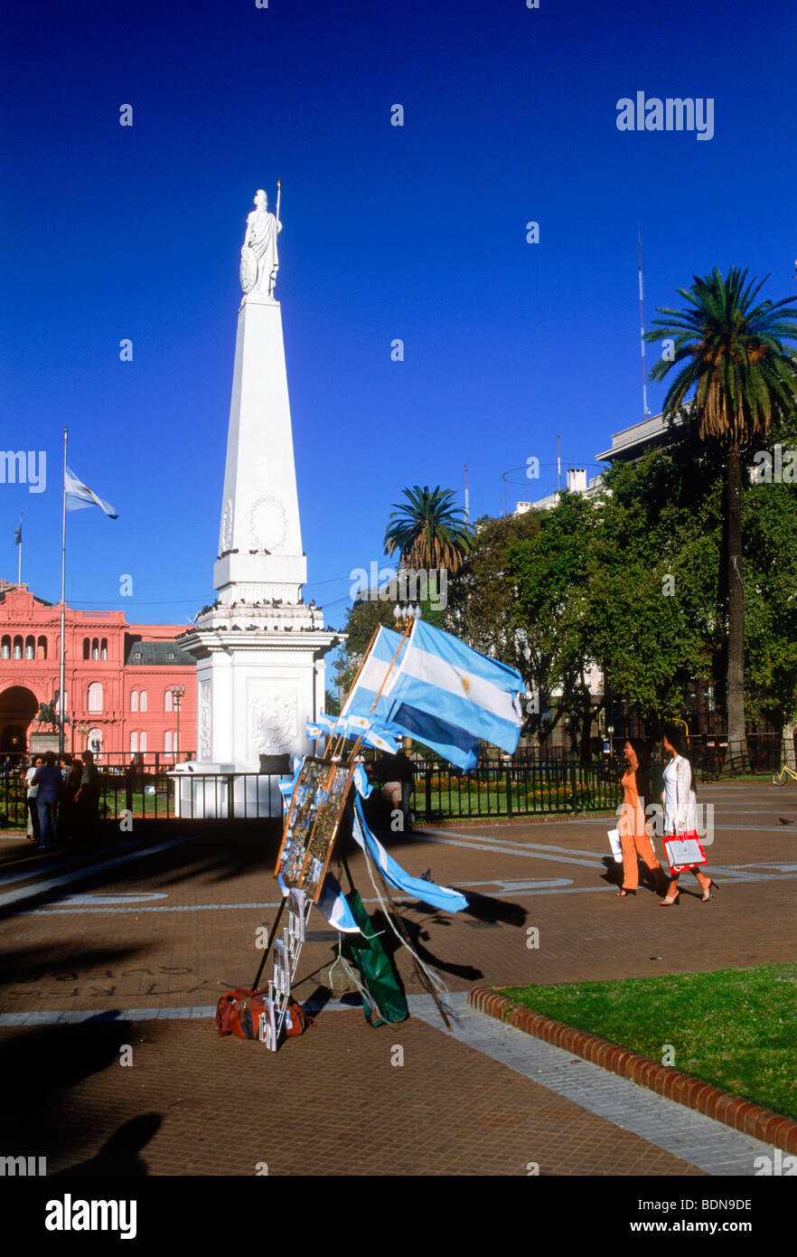People and statue at Plaza de Mayo in Buenos Aires with Argentine souvenir flags Stock Photo