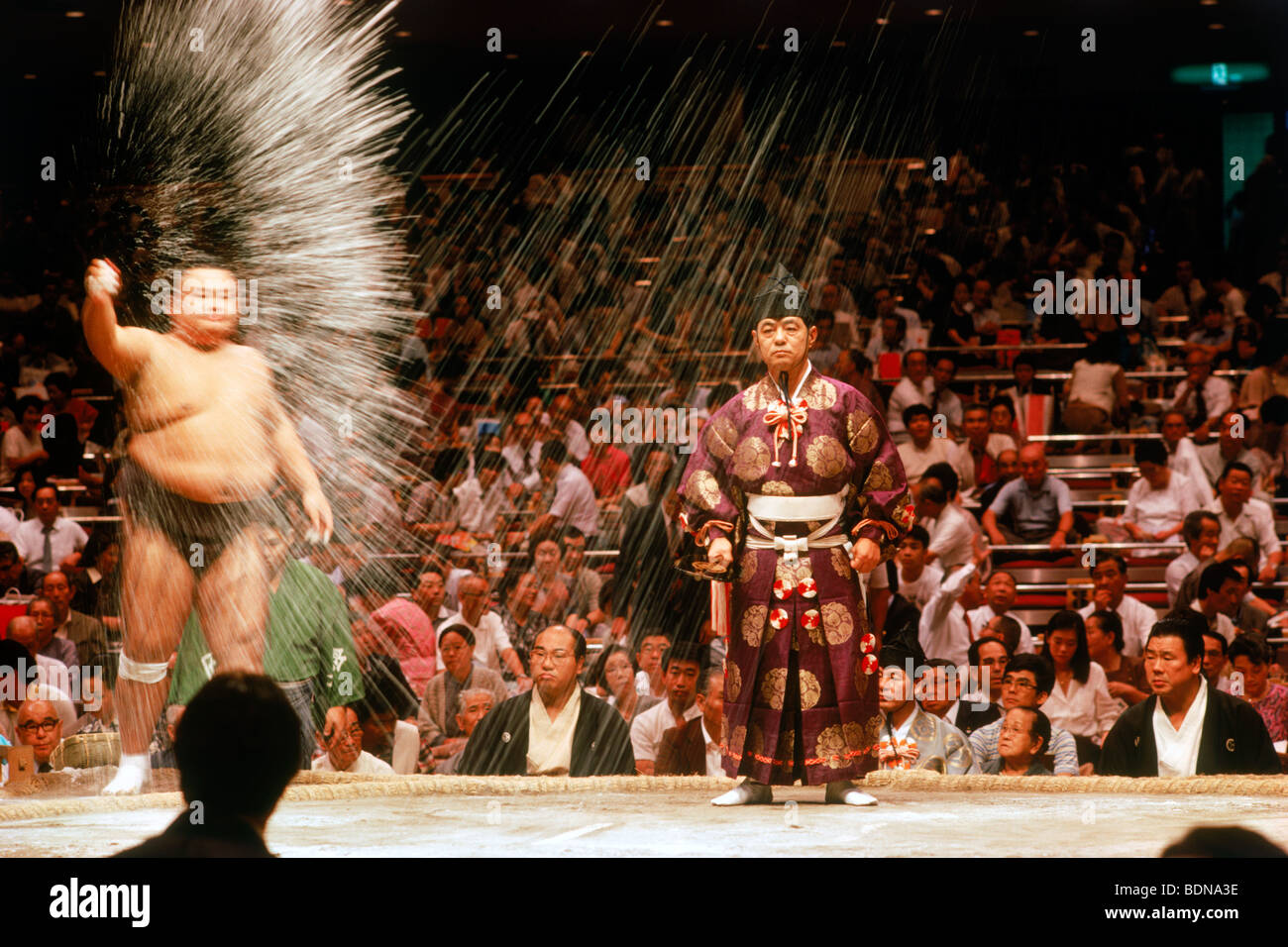 Pre fight sumo wrestling ceremony of tossing salt into ring or dohyo at