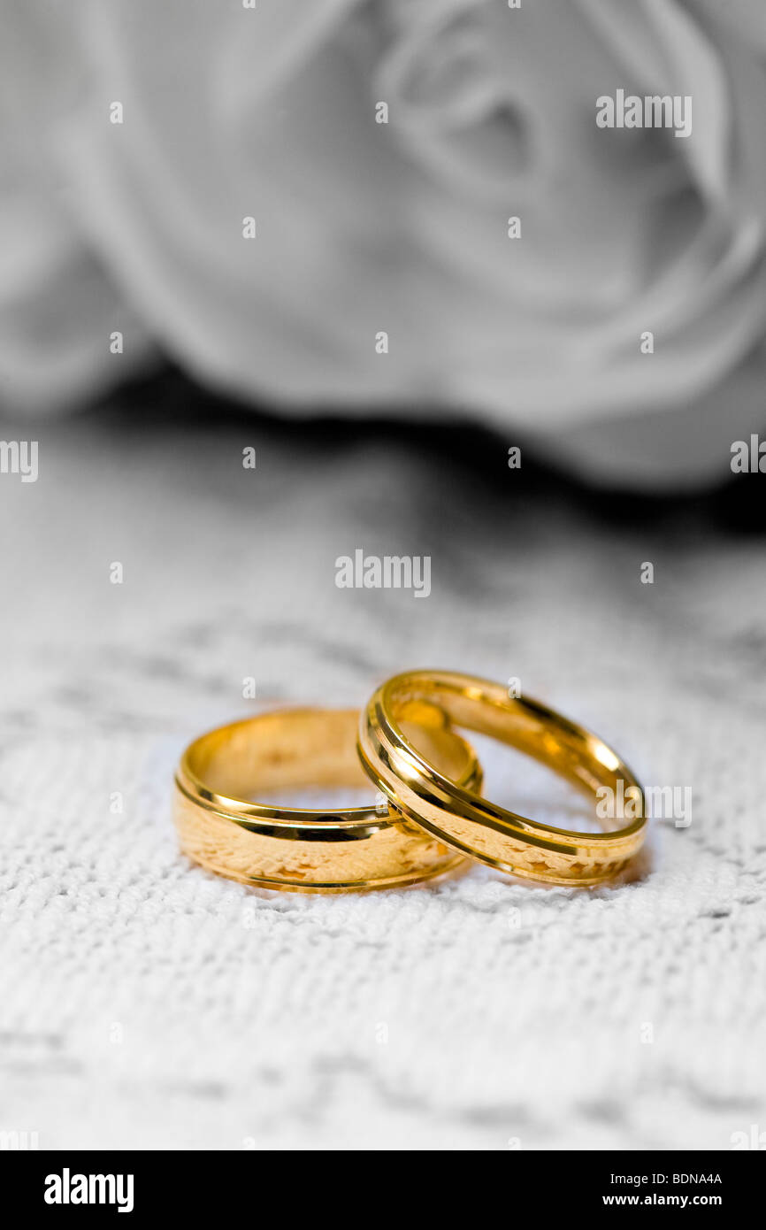 Two gold  wedding  rings  with a digitally altered black and 