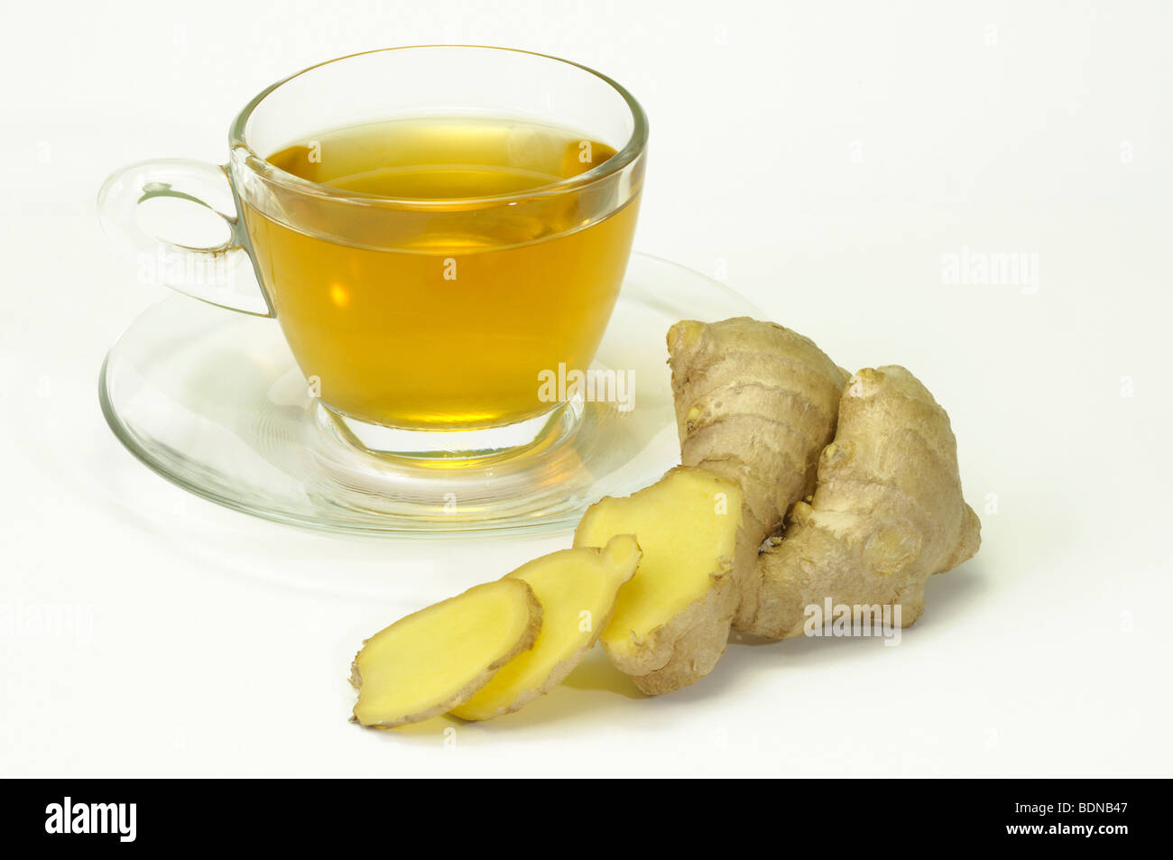 Ginger (Zingiber officinale). A cup of tea with rhizome, studio picture. Stock Photo