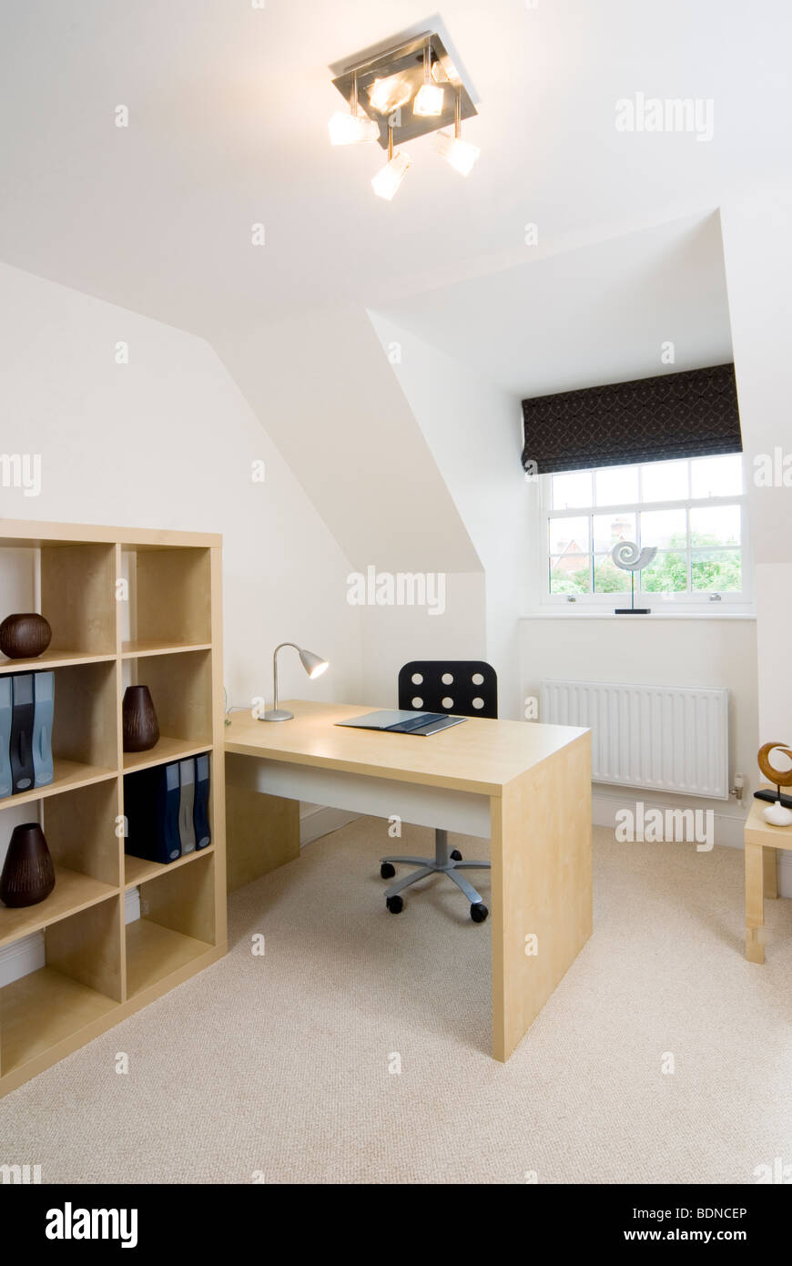 Clean and tidy study area in converted loft space in a modern house ...