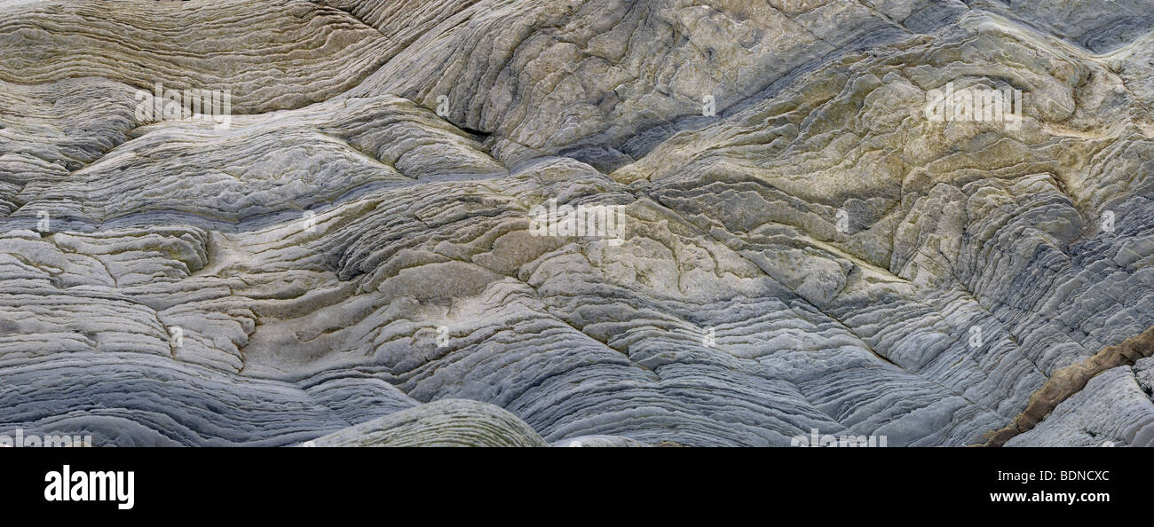 Panorama of abstract pattern of wavy sedimentary layers of stone at Bay of Fundy Cape Enrage New Brunswick Canada Stock Photo