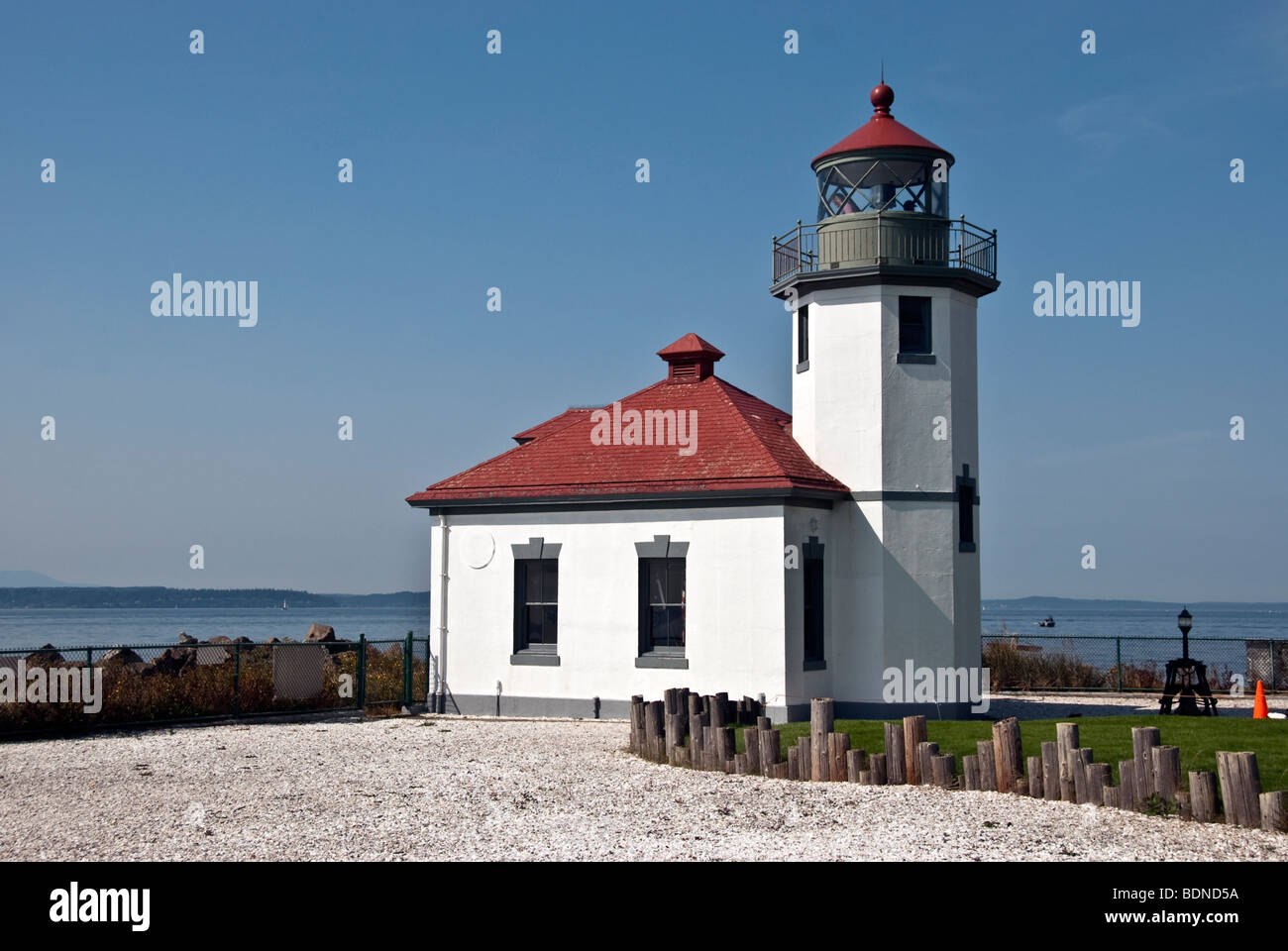 view of the crisply outlined small Alki Point lighthouse on Puget Sound at the entrance to Elliott Bay Seattle Washington Stock Photo