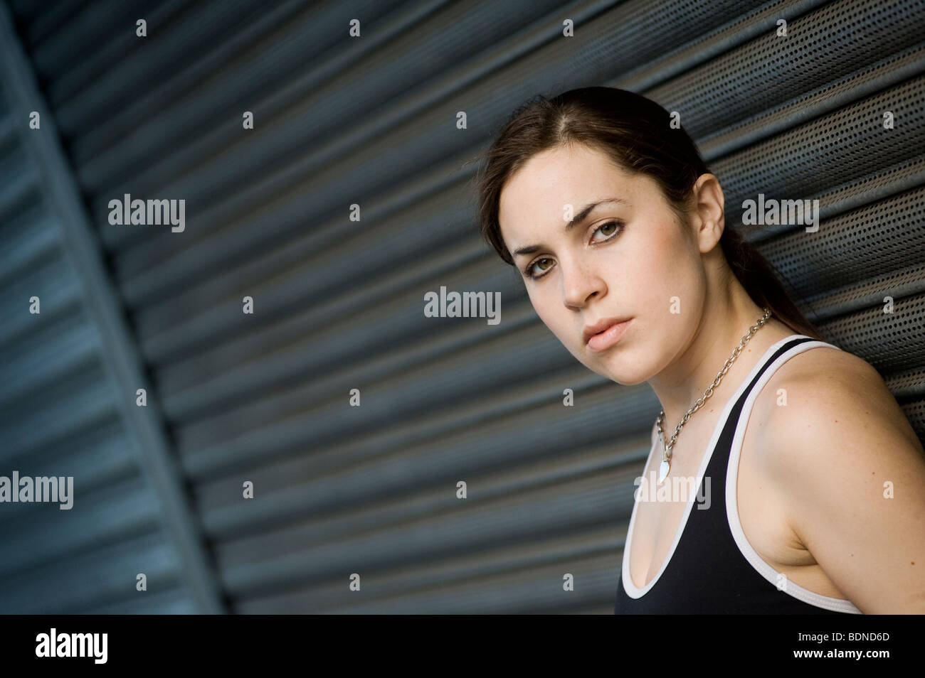 Portrait of a pretty young girl wearing a nike top looking serious outdoors Stock Photo