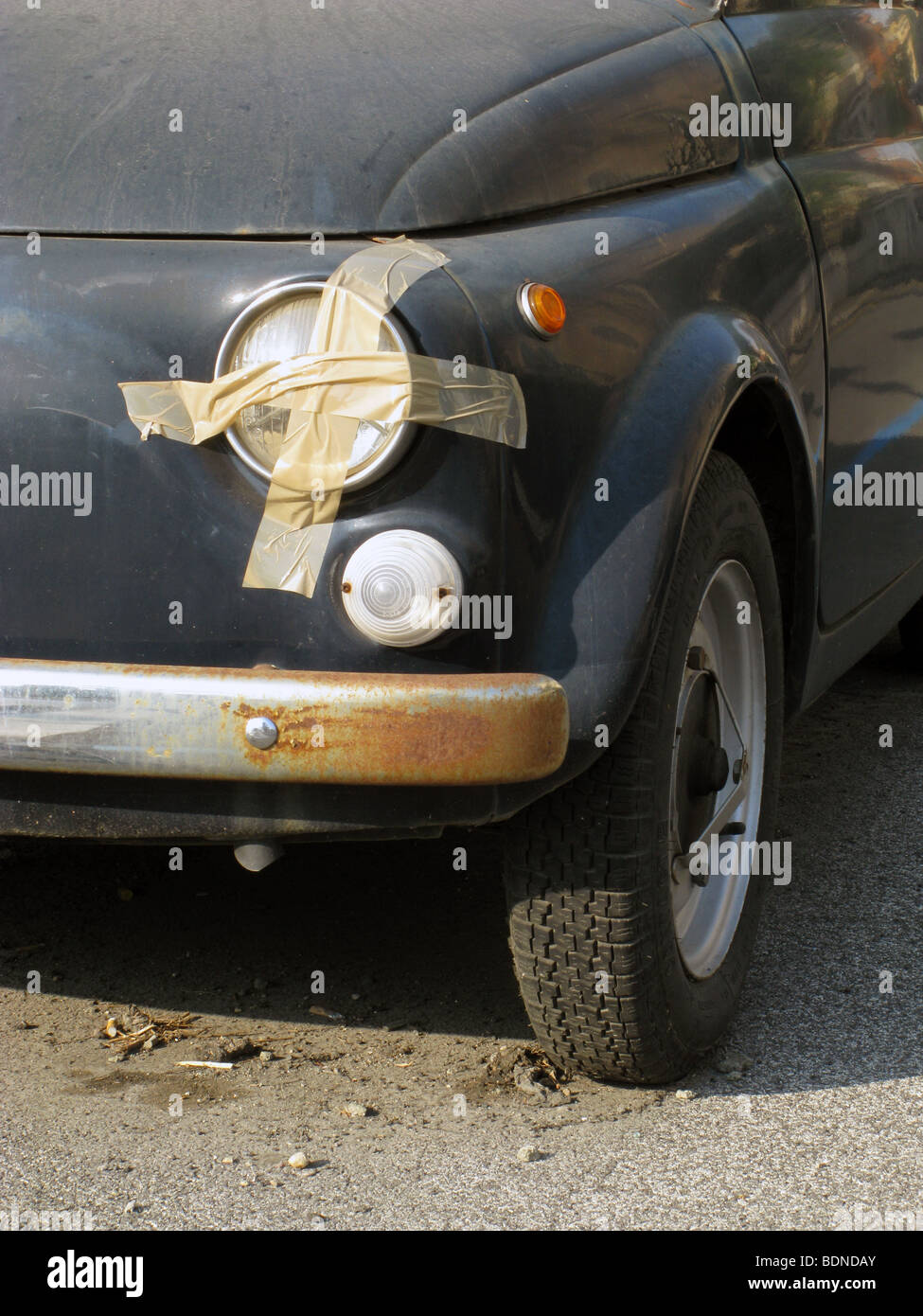 old fiat 500 car with adhesive tape repair on front headlights Stock Photo