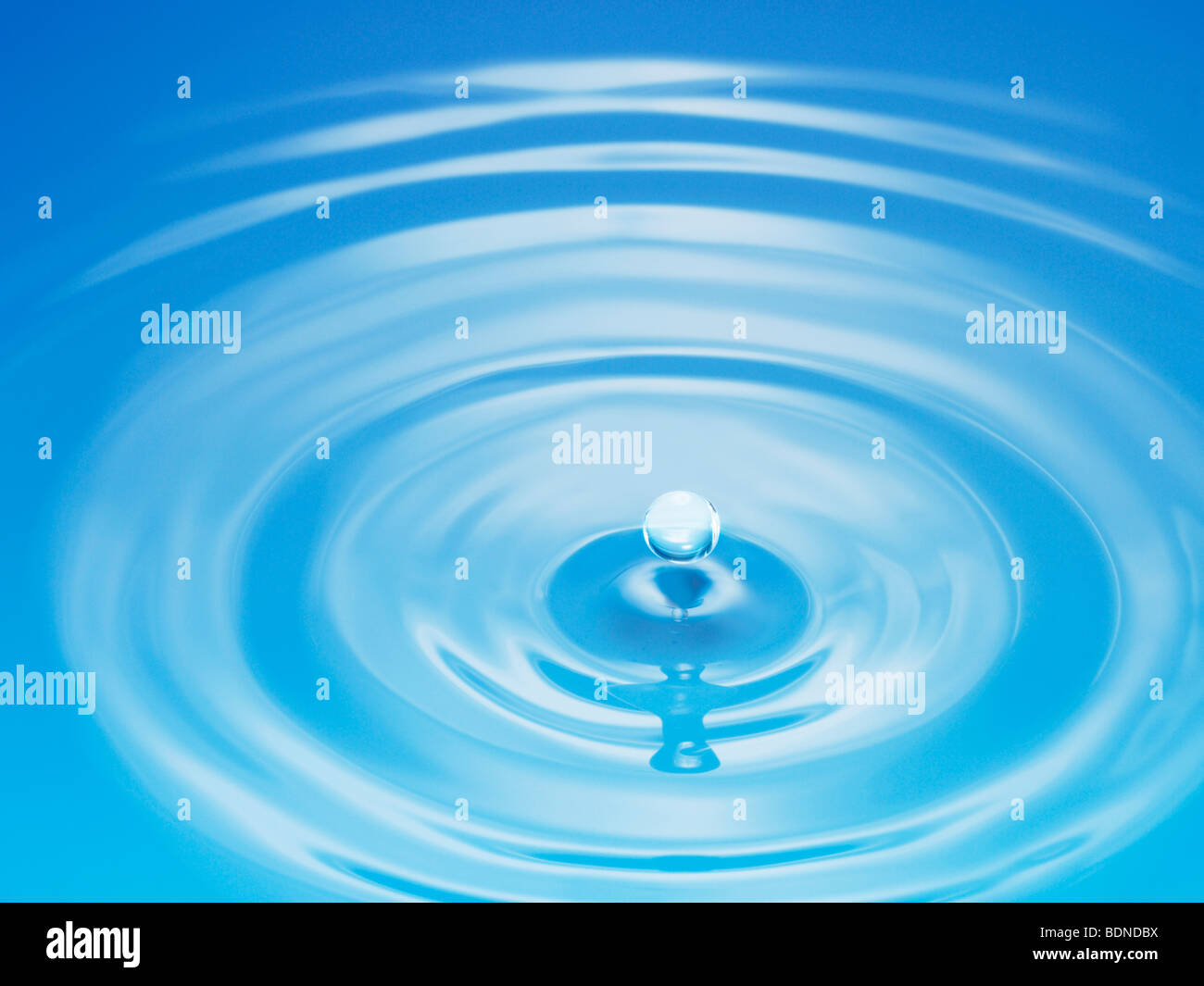 Drop hitting surface of water, close-up Stock Photo