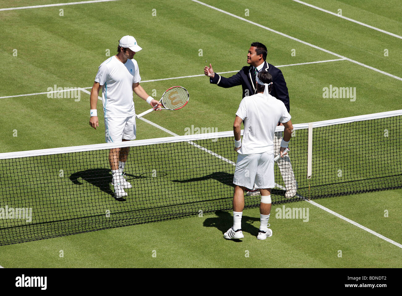 The umpire tosses the coin before the start of the game on court 18 during  the 2009 Wimbledon Tennis Championships Stock Photo - Alamy