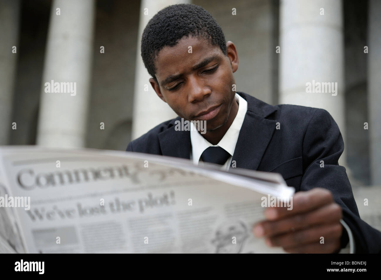 Portrait of young business man reading newspaper, Cape Town, Western Cape Province, South Africa Stock Photo
