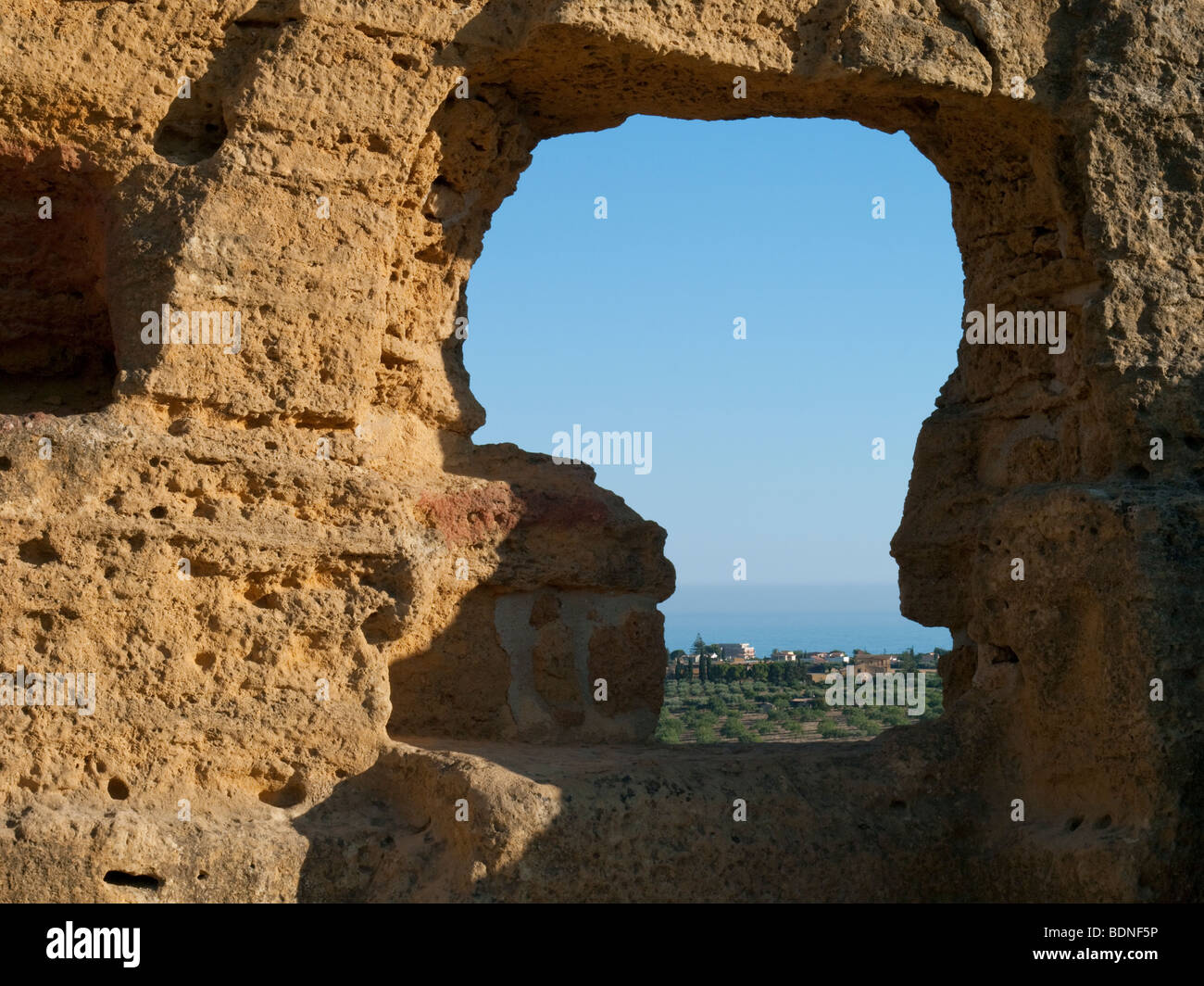 A view of the Mediterranean Sea through the opening of a tomb in the Paleo-Christian necropolis of Agrigento, Sicily. Stock Photo