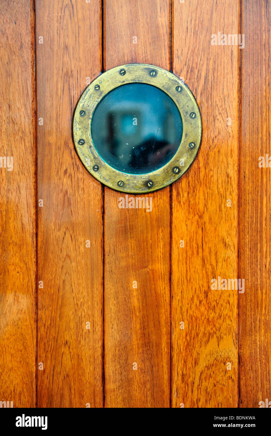 an antique doorway with porthole from a ship Stock Photo